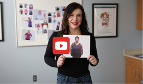 woman that has lost weight showing a photo of her past self